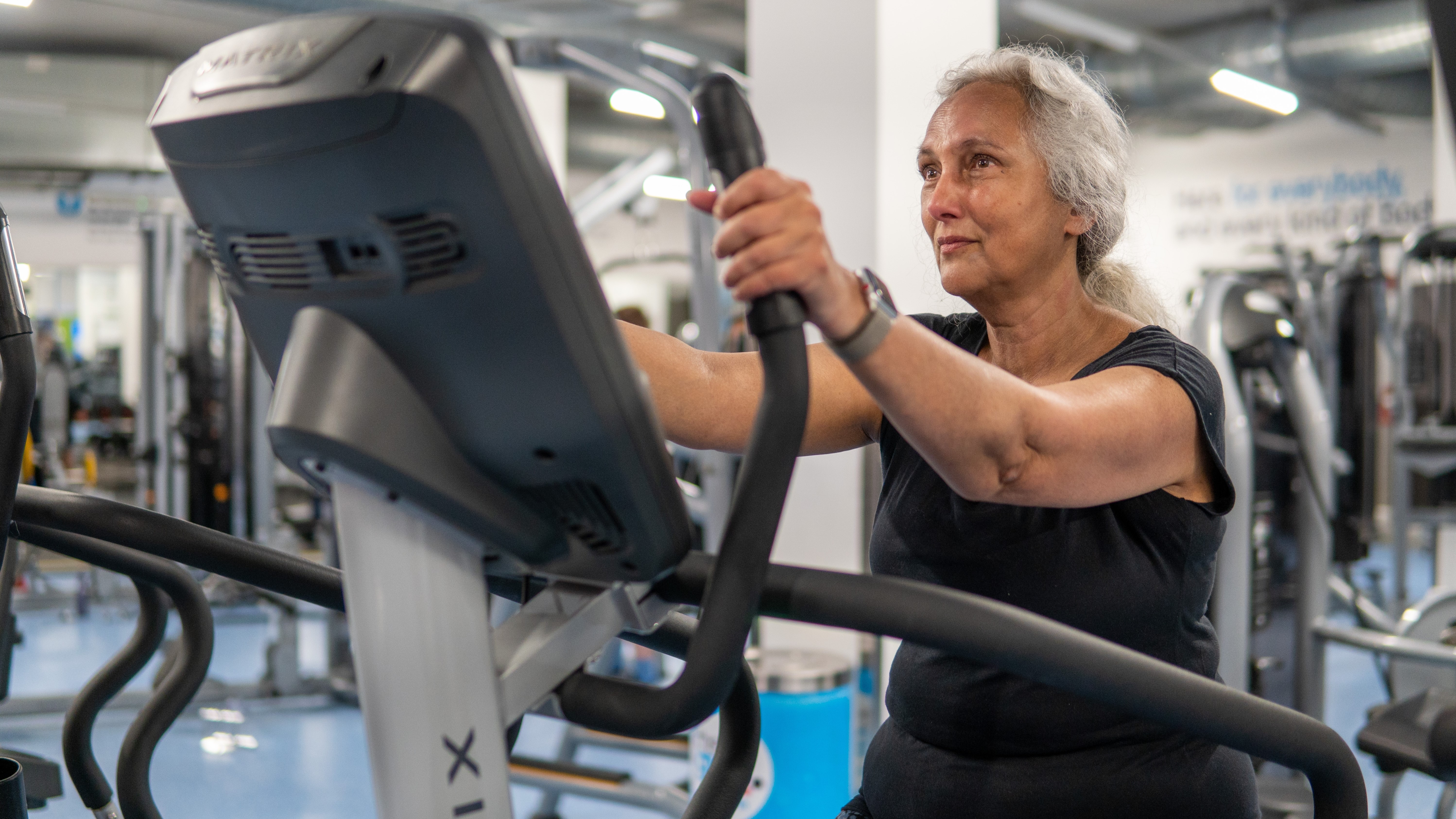 Elderly beginner female working out in the gym