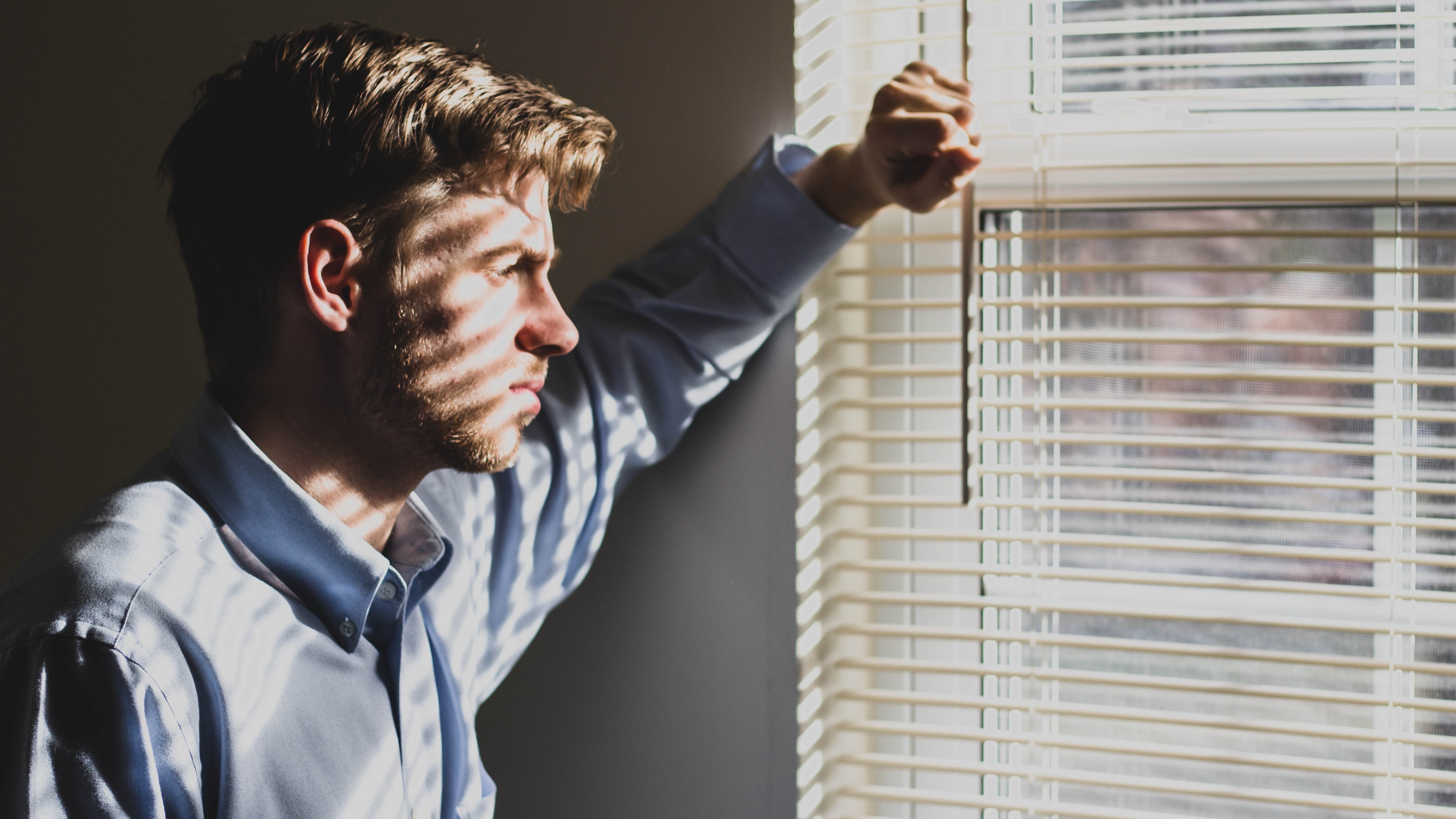Man with depression looking out the window